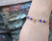Bracelet with small bows and purple glass stones