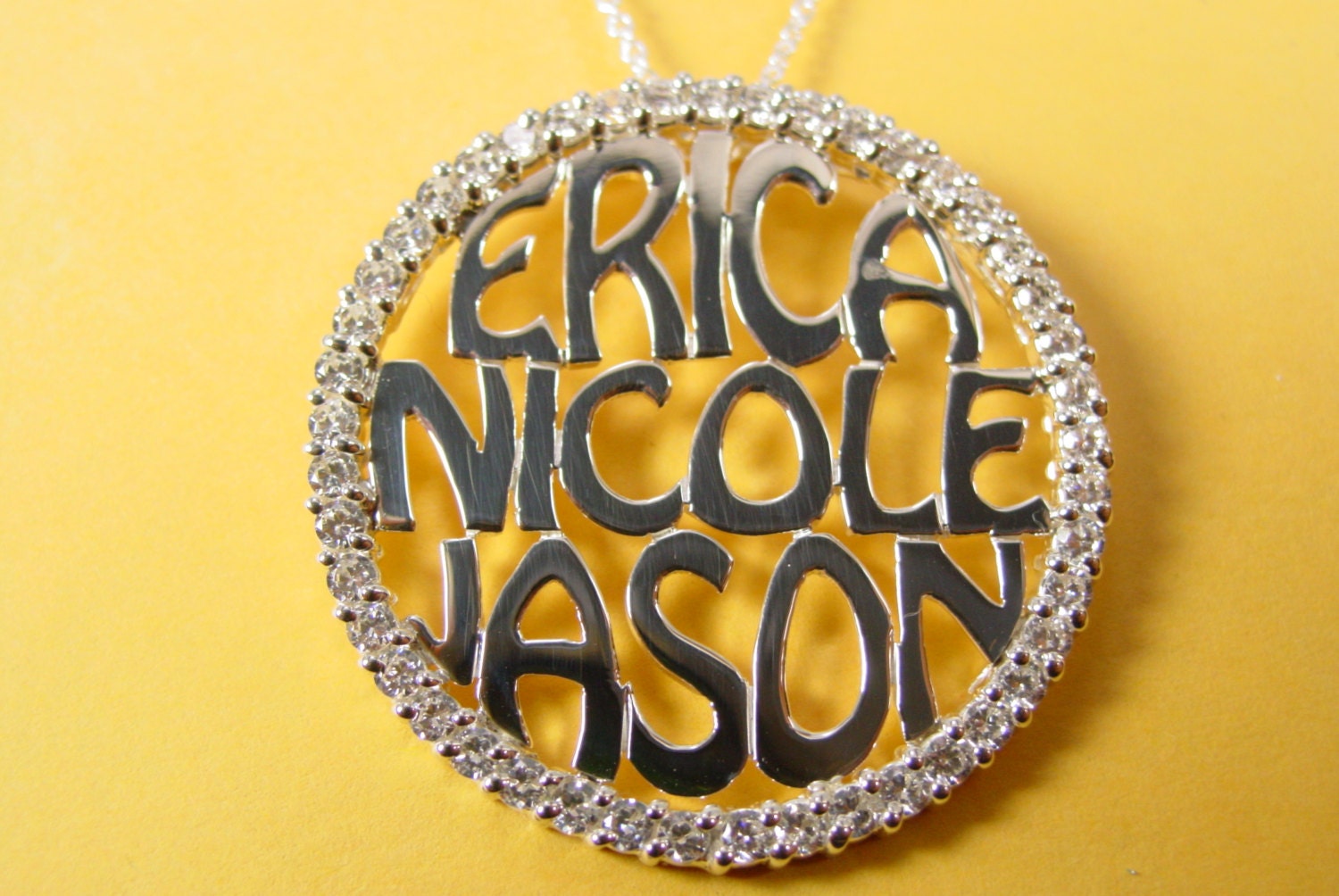 family  pendant with  diamond  bazel.1.s" size  with 46 CZ stones, .sterling silver.whith a chain