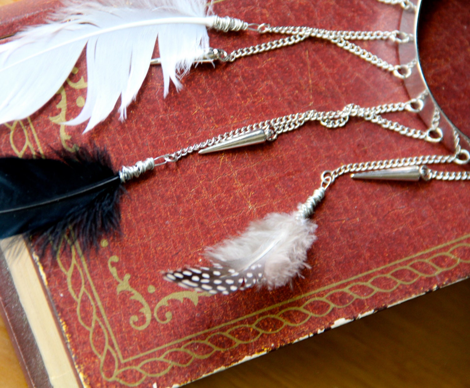 warrior arm cuff - silver tone cuff is adorned with silver spikes wire wrapped feathers black and white
