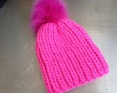 Hot pink neon merino wool beanie with very large fox pom pom