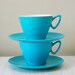 two turquoise Melmex cups and saucers