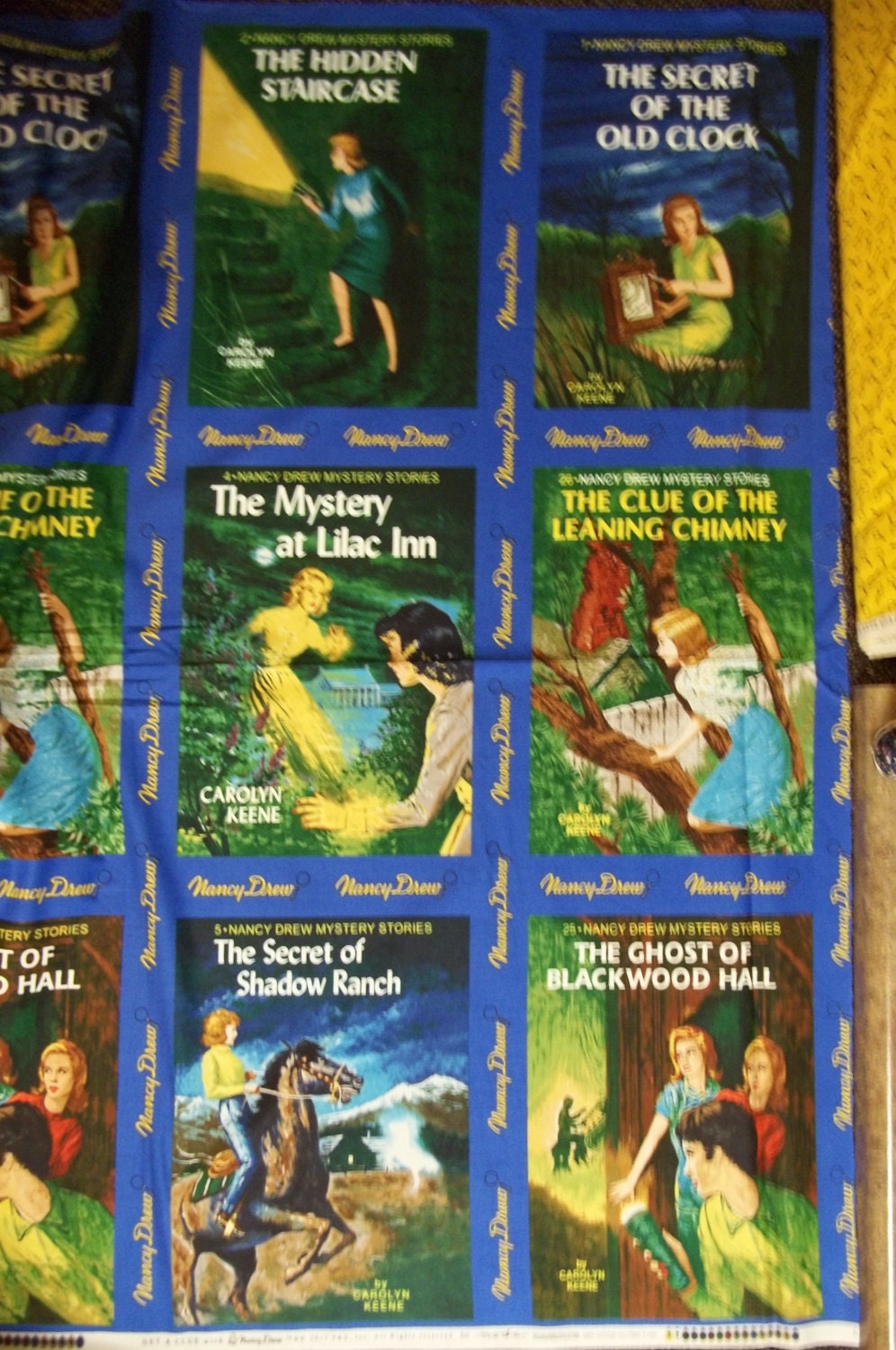 Get a Clue with Nancy Drew 1 Panel  By Moda It show different covers from her mystery novels 2/3 yard panel