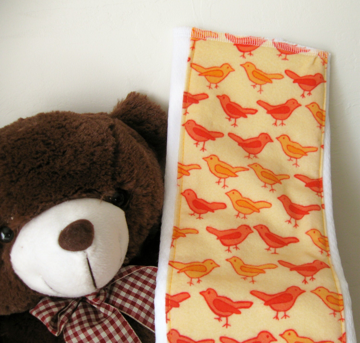 A set of two Orange Birds Burp Cloths