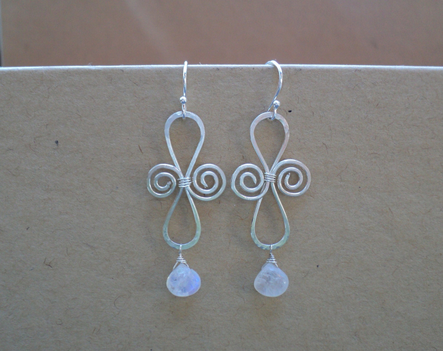 Moonstone and sterling silver organic swirl shaped hand-hammered women's earrings. Sterling silver with rainbow moonstone briolette drops.