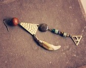 inna.  a single beaded coyote tooth earring.