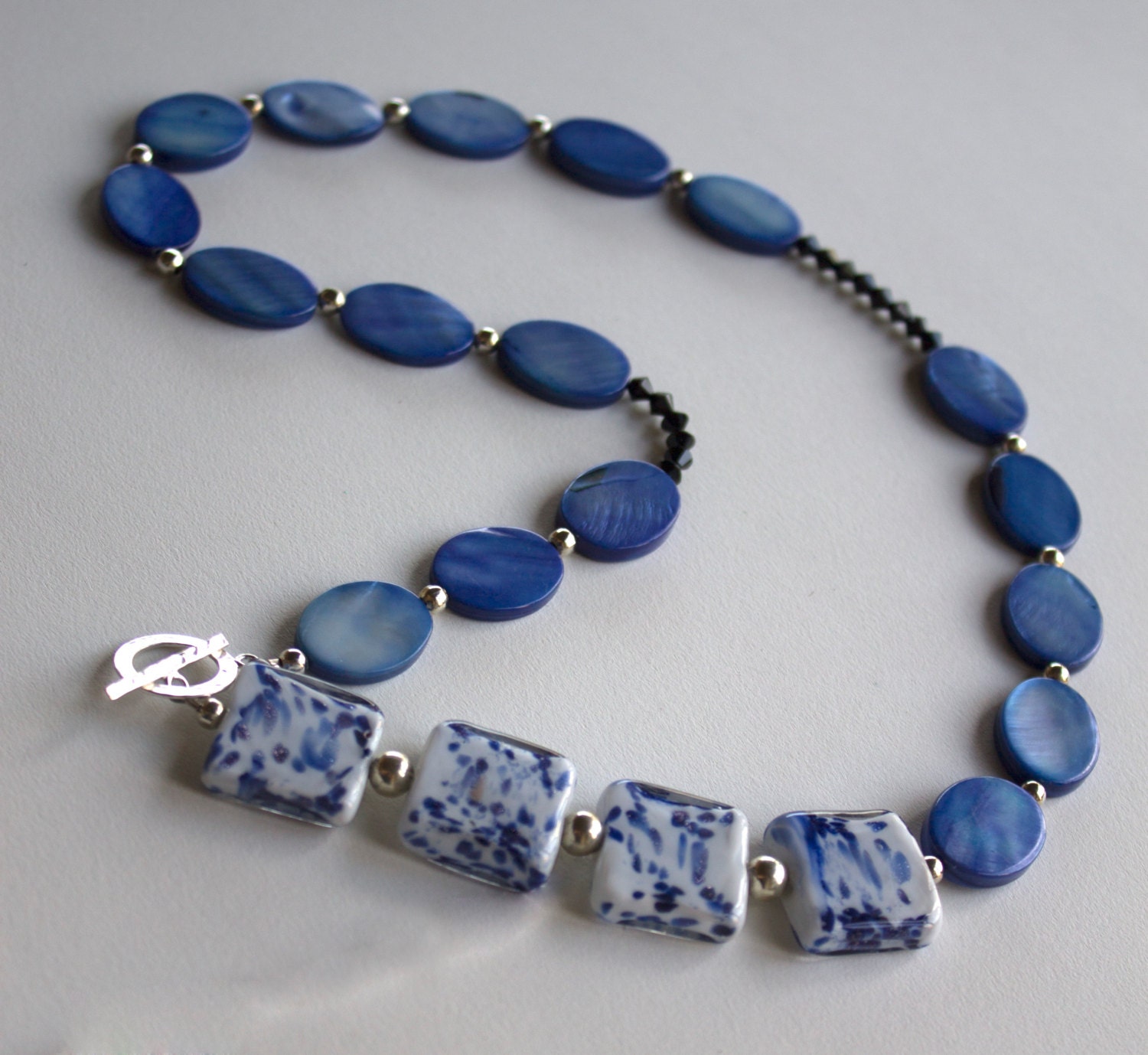 Blue necklace, front closure, mother of pearl and lampwork glass beads, silver plate and sterling silver, swarovski crystals