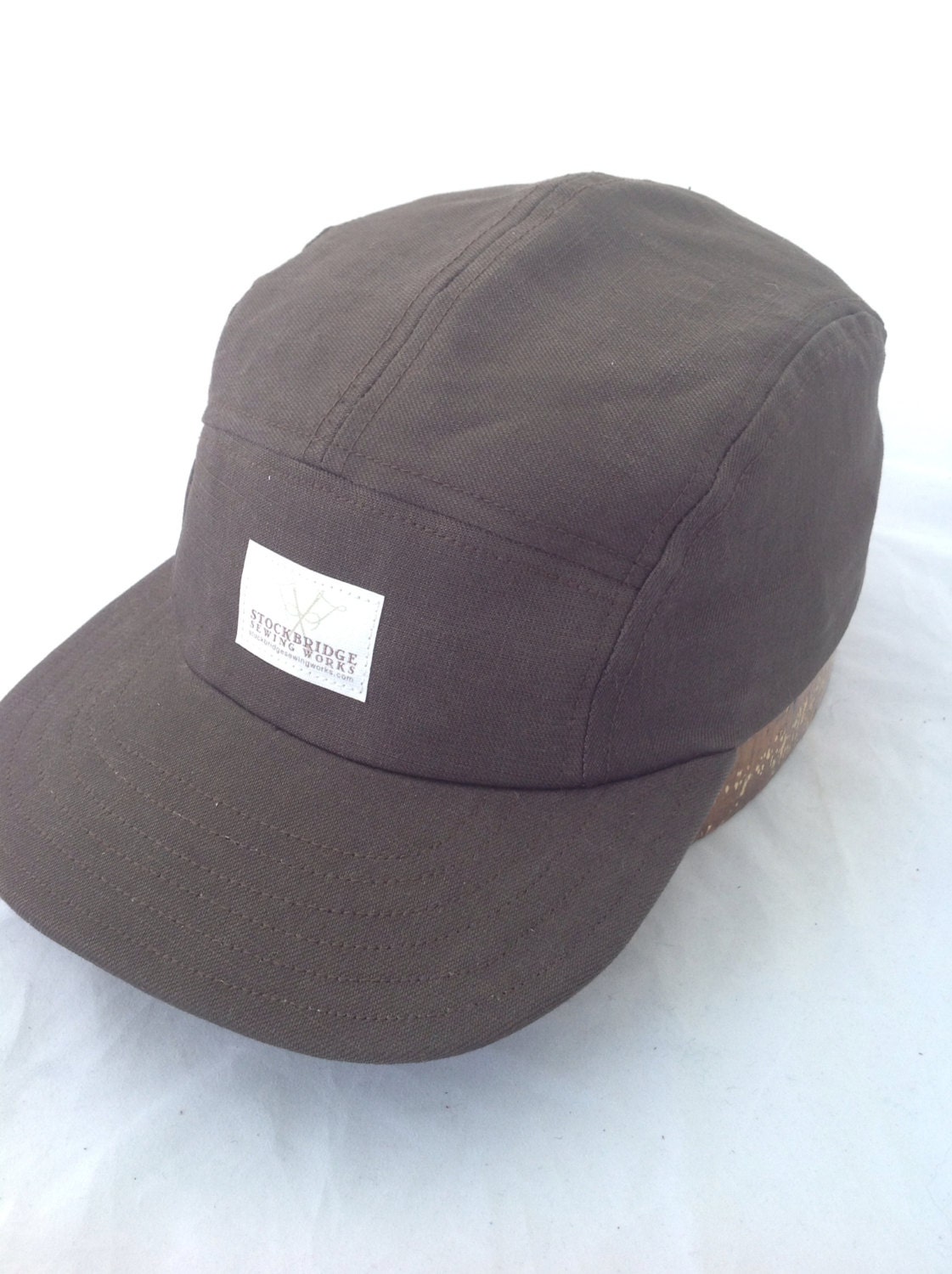 Five panel cap, dark army green twill, flat visor, adjustable buckle, cotton sweatband