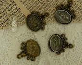 3 anitque bronze oval bezel pendants with  ornate  frame with matching clear cabochons