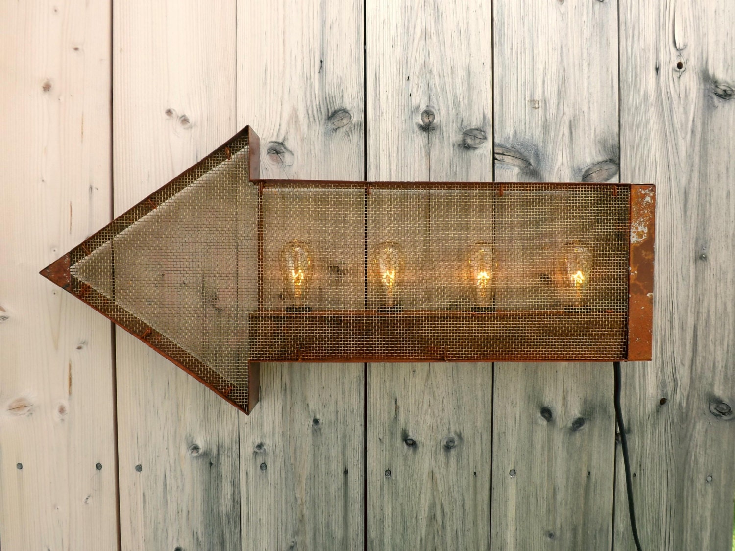 Rusty arrow sign wall light