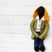 Black crochet rabbit doll.Mustard yellow ears.Vintage style doll.Wearing dark blue jeans and beige striped shirt.Green velvet jacket