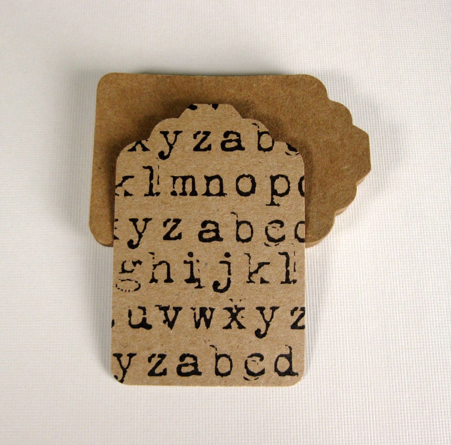 24 Craft Paper Hand Punched Tags With Black Distressed Typewriter Alphabet Pattern