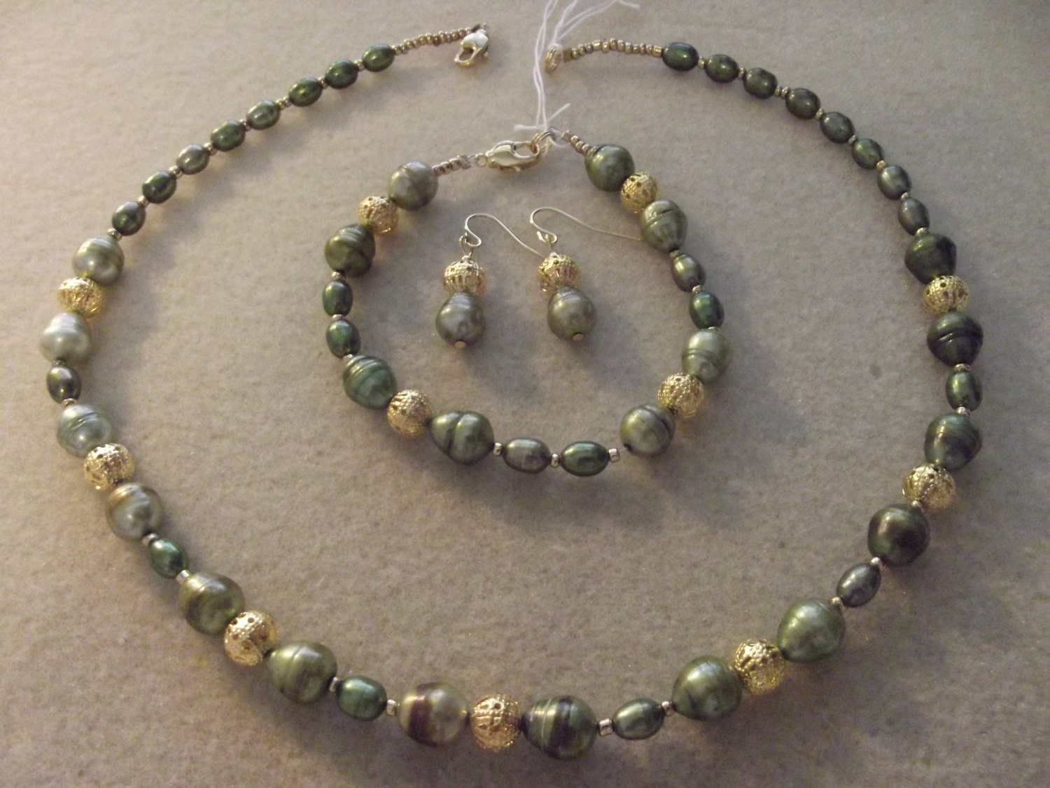 Olive colored pearls with gold bead set , Necklace , earrings, and bracelet .    Freshwater  Rice  Pearls with Gold metal beads