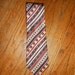 YAPRE vintage men's silk tie. Geometric print in navy, light blue, tan, and red. Wide