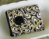 Modern zipper pouch with large retro button detail. Black, white, and yellow.