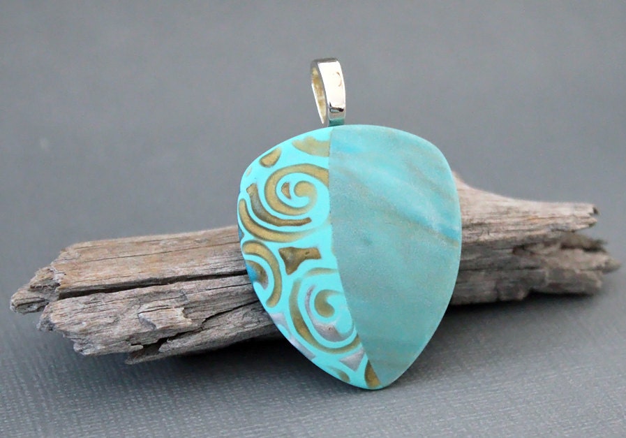 Polymer clay pendant. Teal pendant. Swirls. Swirly. Triangle. Domed. Aqua gold.