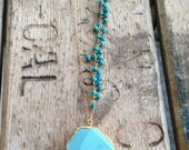 Gold edged turquoise stone pendant necklace with wire wrapped turquoise stones