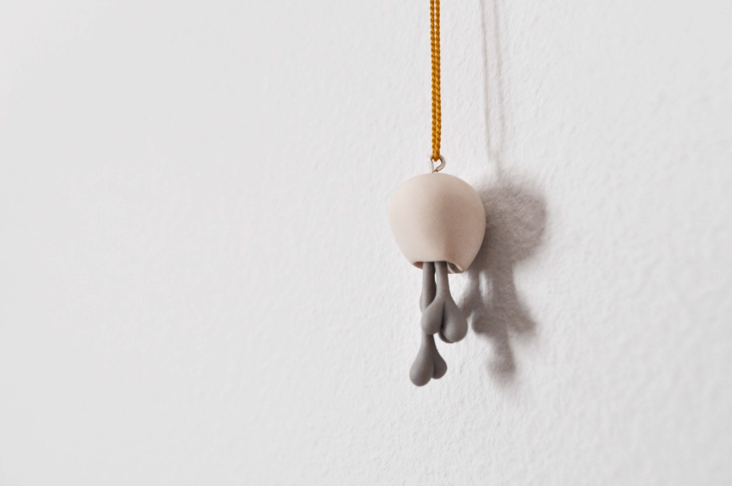 minimalist pod pendant with multiple hearts