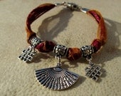 Gypsy Charm Bracelet. Silver Oriental Fan and Chinese Knot Charms. On Burgundy Twine & Orange Organza Ribbon.