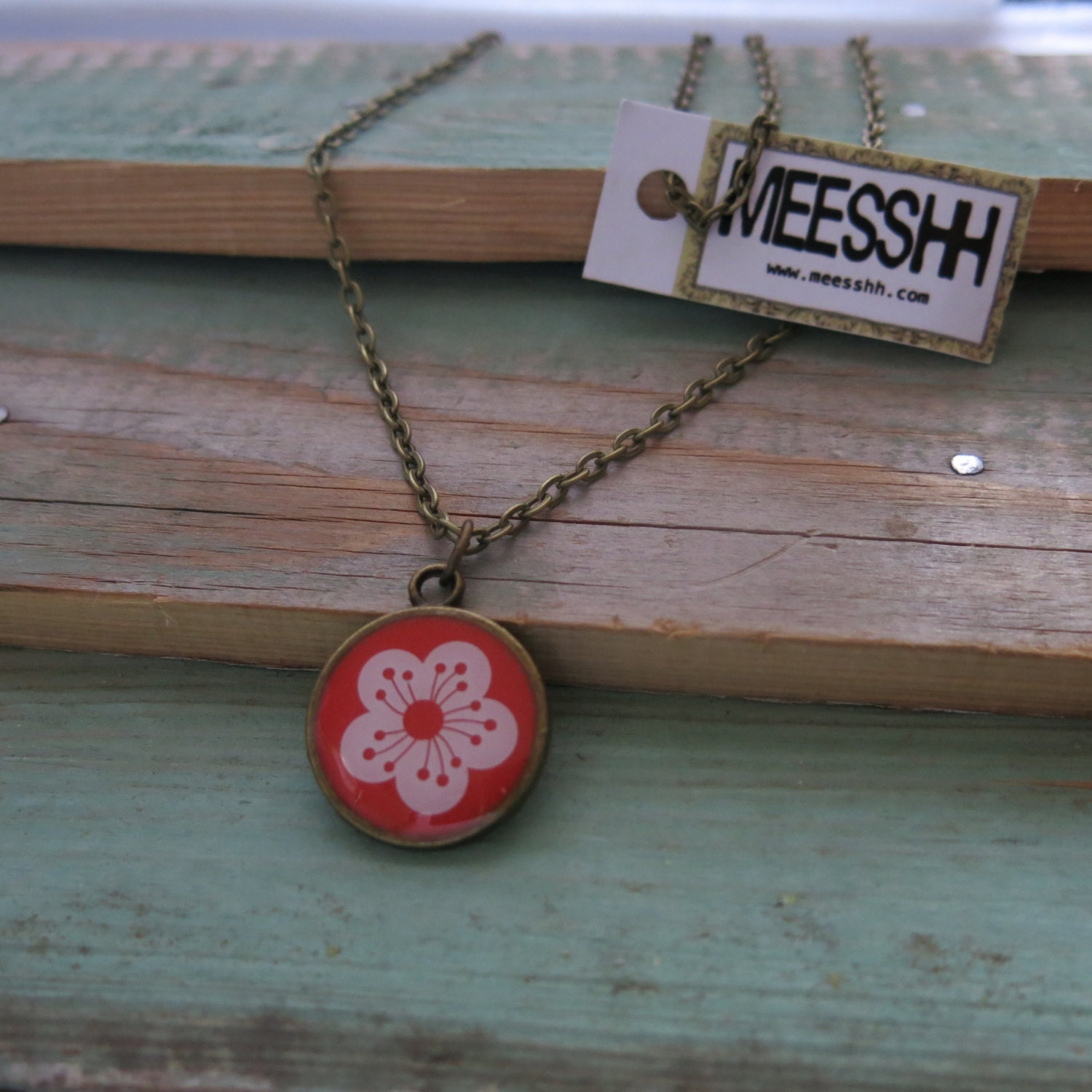 Coral pink pendant necklace with white flower on bronze setting. 22mm.
