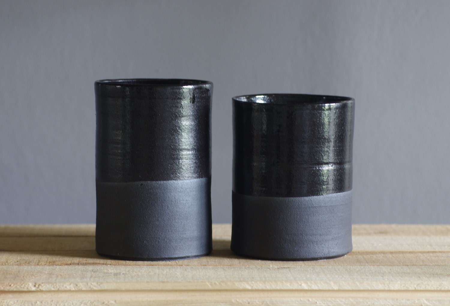 black vase . utensil holder. straight tall vessel . black stoneware with black glaze. modern kitchen pottery minimal ceramics