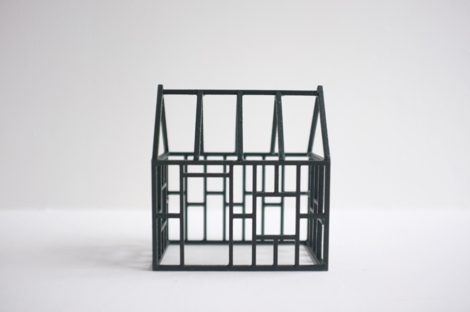 Dark forest green geometric wood frame house structure