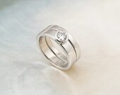 palladium bridal set with tapered bezel-set diamond engagement ring