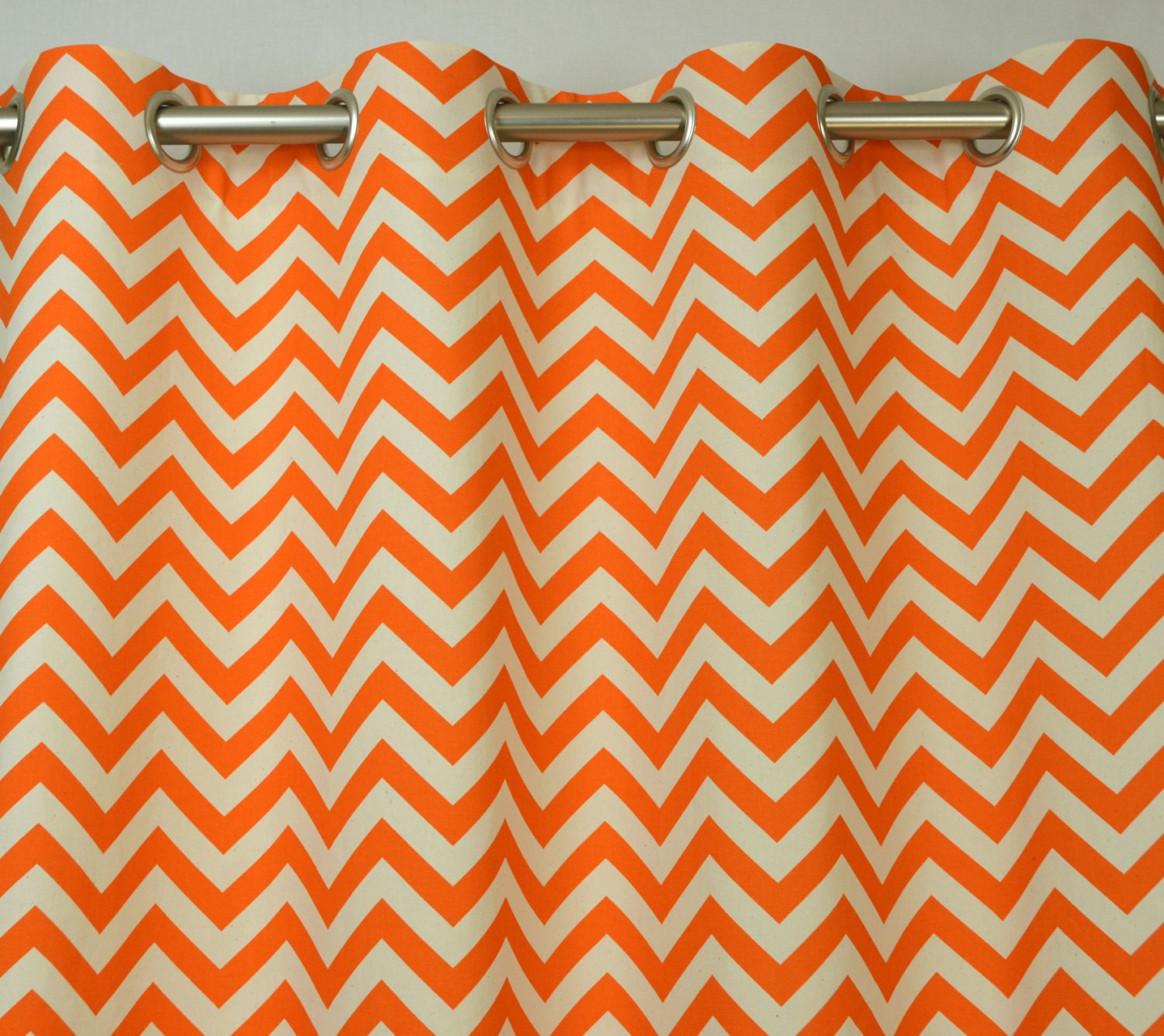 Pair of Grommet Top Curtains in Mandarin Orange and Natural Chevron Zig Zag Print