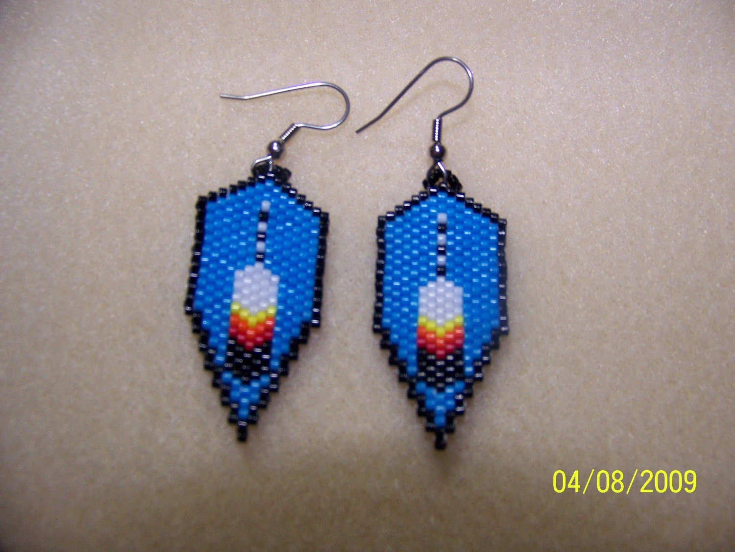 small shield and feather brick stitch beaded earrings