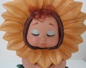 Sunflower Baby Sitting on a Flower Pot