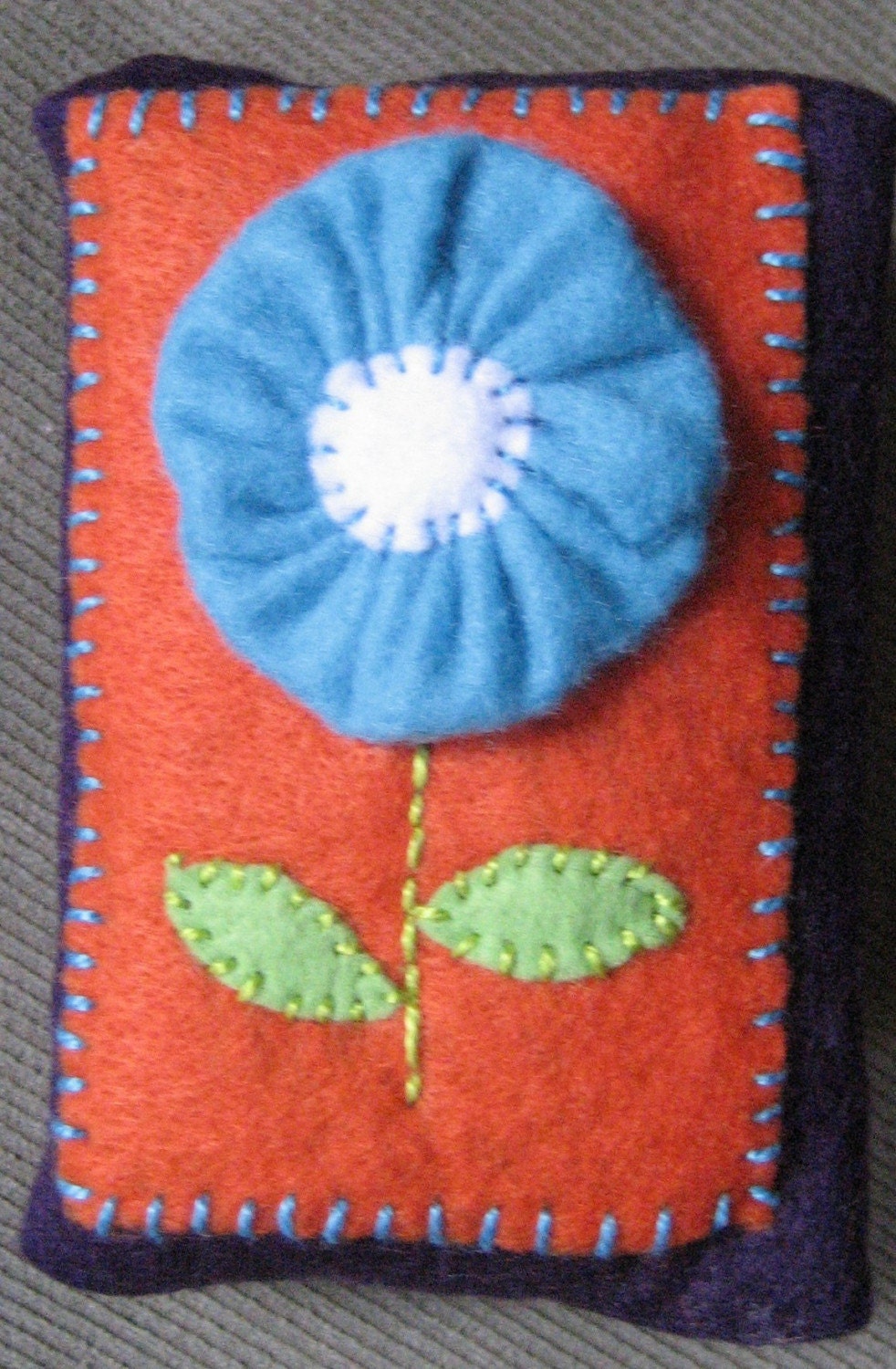 Turquoise Bubble Flower on Orange Background on Dark Purple Tissue Cozy