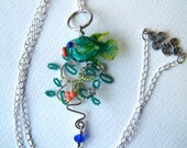 An Artisan Handmade Glass Fish in Sea Plants in Teal, Coral and Grass green on Sterling silver chain