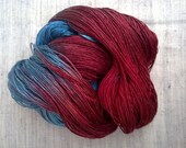 Topaz and Ruby Striping Selkie -  rich red and aqua blue silk and seacell fingering yarn.