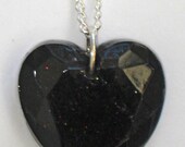 Black gemstone shape heart necklace with red sparkle
