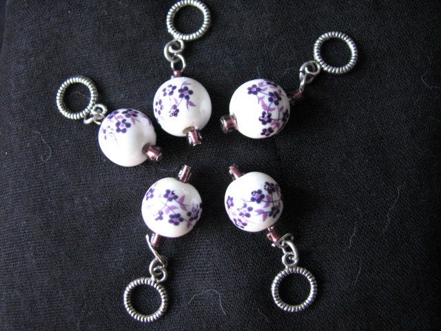 White and purple stitch markers