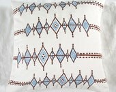 Off white 18 inch throw pillow with brown & blue diamond embroidery