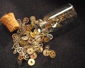Glass Vial Filled With Teenie Tiny Watch Gears And Parts