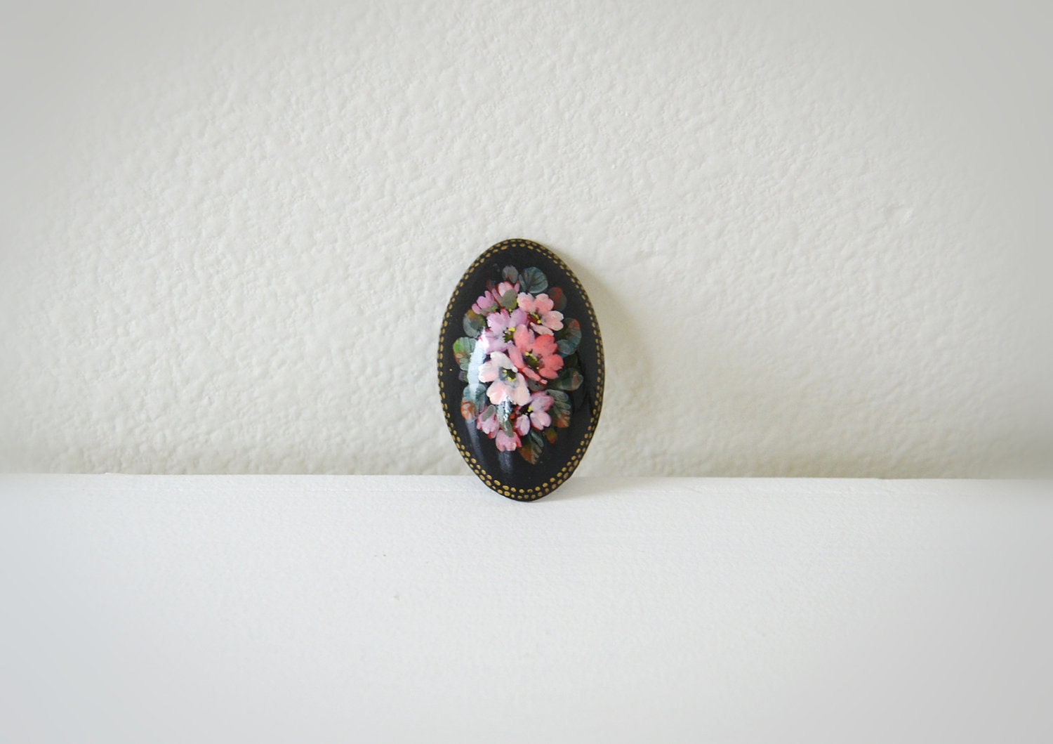 Vintage black wooden floral brooch.