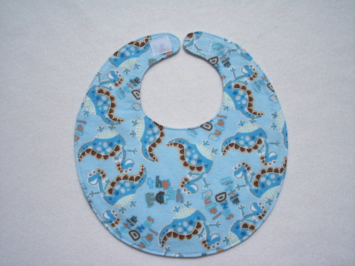 Baby bib, four soft layers, reversible, blue with blue dinos
