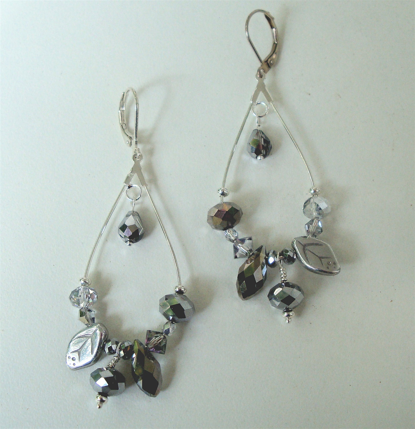 Silver elongated hoop earring with silver crystals and glass beads