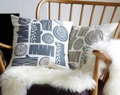 Log pile cushion on white linen