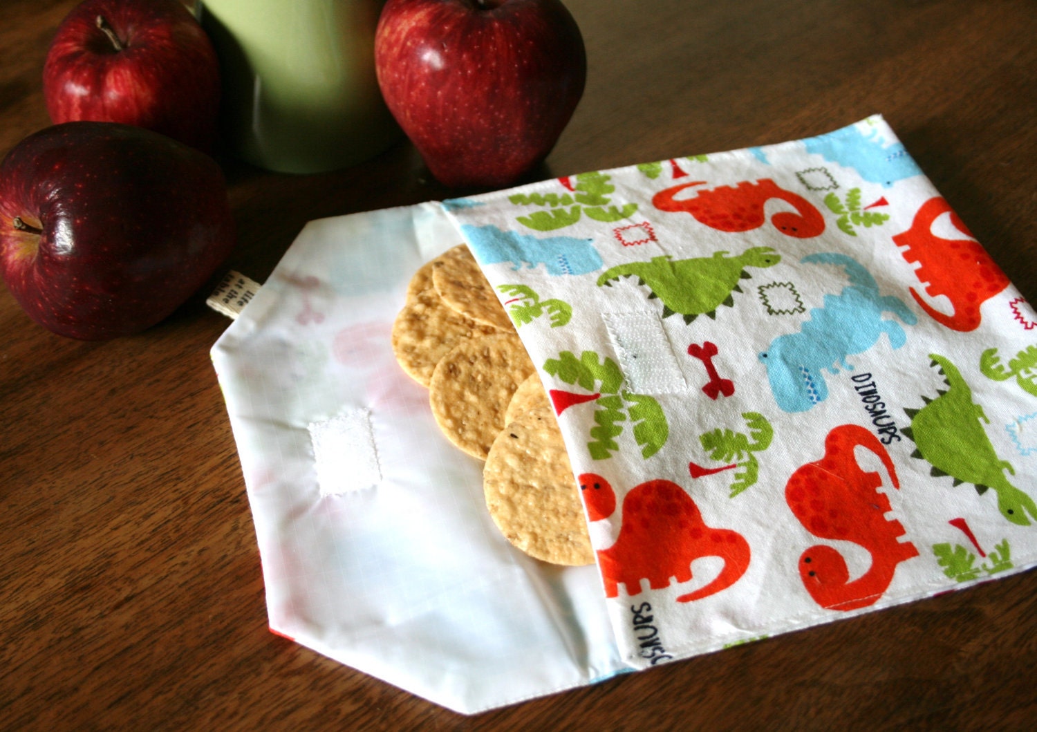 pair of reusable, lined sandwich bags in dinosaur & green