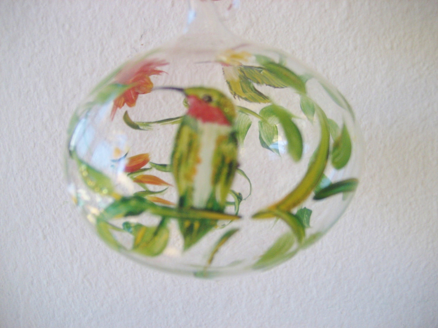 Glass Christmas ornament with hummingbirds and trumpet vine flower, hand painted.