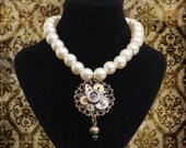 Pearl necklace with steampunk pendant made from vintage watch parts and a filigree mount