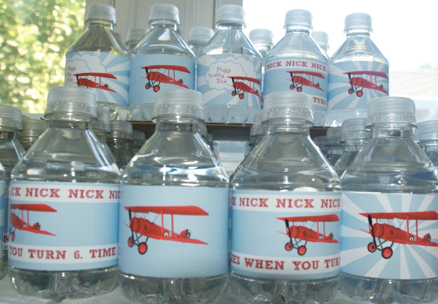DIY printable custom water bottle labels in vintage red and blue airplane theme.