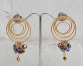 Matte Gold plated over brass hoop earring with sterling silver post and dangling crystals.