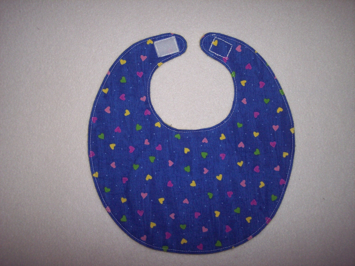 Baby Bib, four soft layers, reversible, blue with pink, green, and yellow hearts