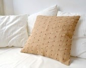 Burlap cushion cover with red cotton knots