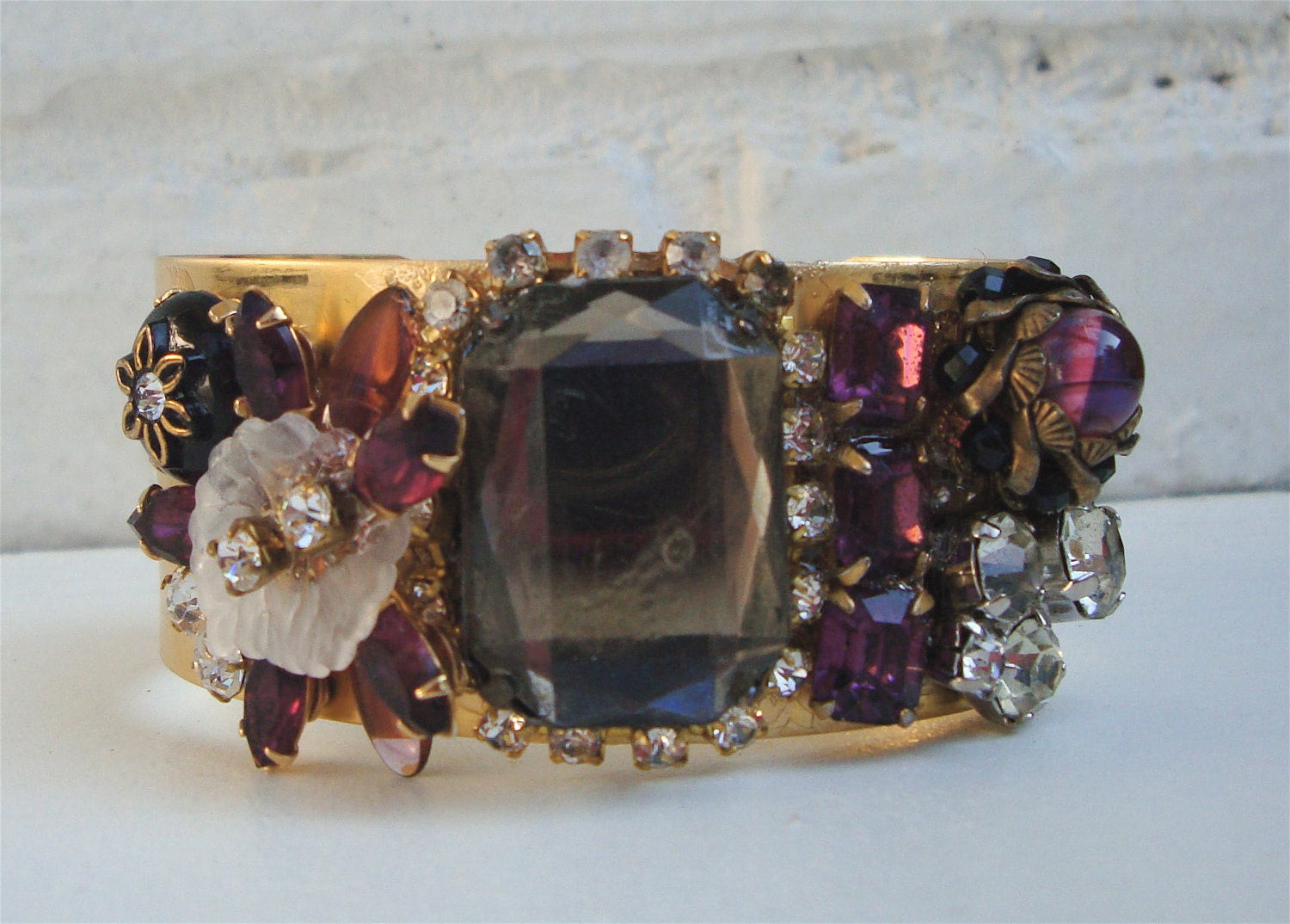Vintage shiny brass cuff bracelet with smokey crystal center, recycled vintage pieces, crystals, rhinestones & leaves.