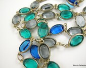 A beautiful collet-set necklace with blue, teal and gray - sometimes a little violet - faceted glass. The clasp is unique and has a patent number. Otherwise, unsigned. Overall length of this gorgeous necklace is 29-1/2 inches. The colors are truly remarkable and I can't take my eyes off them!