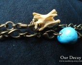 Divine -  turquoise, squirrel spine and chandelier glass on antiqued brass